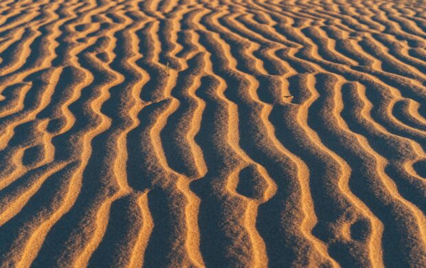 brown sand with shadow of person