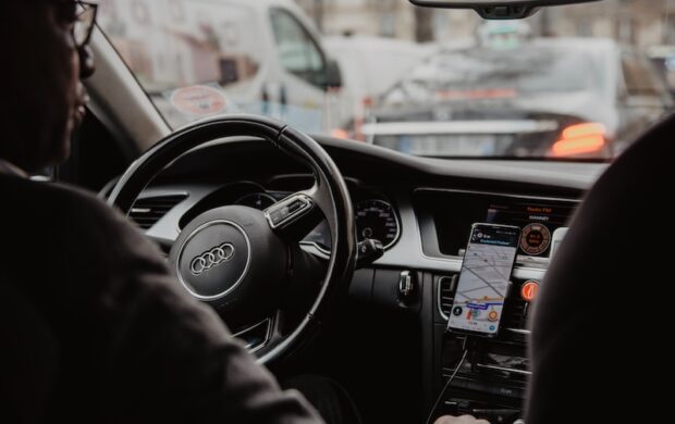 man in black jacket driving car during daytime